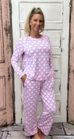 Slip into comfort with our Annie Pajamas, the perfect blend of cozy and cute. This two-piece set features a long sleeve scoop neck top and long pants with a 27” inseam. Designed with an elastic waistband, adjustable drawstring, and side pockets, these pajamas are made from a soft, stretchy blend of 94% polyester and 6% spandex—giving you that just-right feel for lounging or bedtime.