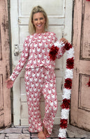 Slip into comfort with our Annie Pajamas, the perfect blend of cozy and cute. This two-piece set features a long sleeve scoop neck top and long pants with a 27” inseam. Designed with an elastic waistband, adjustable drawstring, and side pockets, these pajamas are made from a soft, stretchy blend of 94% polyester and 6% spandex—giving you that just-right feel for lounging or bedtime.
