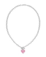 Fall for the Ari Heart Silver Necklace in Pink Iridescent Glitter Glass! Featuring a heart charm, enamel frame, and trendy link chain with toggle closure, it’s convertible too!