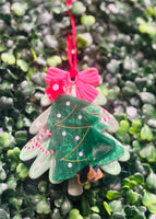 Festive acrylic Christmas claw clips in tree, gingerbread man, present, and snowman designs. Perfect for holiday hairstyles!