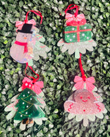 Festive acrylic Christmas claw clips in tree, gingerbread man, present, and snowman designs. Perfect for holiday hairstyles!