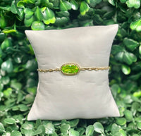 Elaina Luxe Chain Bracelet gold light green with cubic zirconia oval stone on silver paperclip chain.