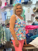 Flirty, feminine, and made for sunny adventures. The Lulu-B Cha Cha Tank in MCDR features a beautiful tropical floral and water scene with charming dragonfly details — front and back ruffles, a scoop neckline, and a straight hemline give it a playful, resort-inspired silhouette that pairs effortlessly with any bottom for an effortless warm-weather look. Soft, stretchy fabric with UPF 50 protection and a 30.5" length make it as practical as it is pretty, whether you're at the beach, out for brunch, or soakin