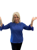 Elevate your everyday style with the Lulu-B FX Cashmere Scoop Neck Sweater Top. Luxuriously soft and lightweight, this must-have piece combines comfort with chic detail. The scoop neckline flatters every figure, while playful fringe on the elbow-length sleeves adds just the right touch of charm. Dress it up with slacks for work or pair with jeans for a polished casual look—you’ll love how effortlessly versatile it is.