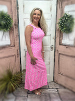 dress features a cutout back that adds a touch of allure and a straight fit that flatters your figure.
pink/green/white geometric printed maxi dress with cut outs on the back of the dress