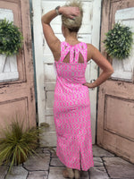 dress features a cutout back that adds a touch of allure and a straight fit that flatters your figure.
pink/green/white geometric printed maxi dress with cut outs on the back of the dress