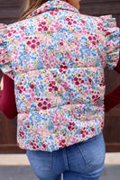 This puffer vest features a gorgeous floral pattern and playful ruffle sleeves, making it the perfect choice for those looking to add a touch of color to their outfit. Don't miss out on this must-have item!