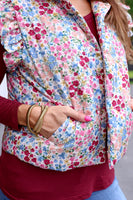 This puffer vest features a gorgeous floral pattern and playful ruffle sleeves, making it the perfect choice for those looking to add a touch of color to their outfit. Don't miss out on this must-have item!