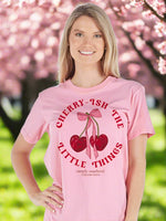 simply southern tee
cherry-ish the little things 
features cherries with a bow 
printed on a pink tee