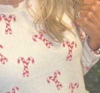 Festive Candy Cane Print – Perfect for Christmas mornings
 Relaxed Fit Crew Neck Top – Soft and breathable
Straight Leg Pants with Elastic Waistband & Drawstring – Adjustable comfort
Elastic Cuffs at Ankle – Stay-in-place fit for cozy wear
Inseam: 27"
Fabric: 96% Polyester / 4% Spandex – Stretchy