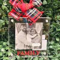 Decorative photo ornament with a red plaid bow and 'FAMILY' text on a green leafy background