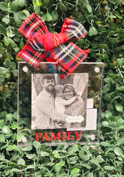 Decorative photo ornament with a red plaid bow and 'FAMILY' text on a green leafy background
