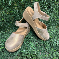 wedge in shimmering rose gold metallic. Featuring lightweight EVA cushioning and a secure Velcro ankle strap, these stylish wedges absorb impact for effortless wear