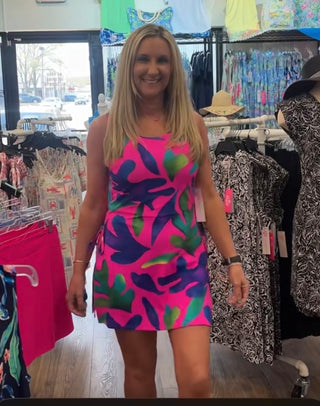 Bright, tropical, and made for your best sunny days. The Amari Skirted Romper in Pink Palm Parade brings a playful, vacation-ready energy to every warm-weather occasion — built-in shorts for comfort and coverage, a zip-up back for easy wear, and a lightweight, breathable, wrinkle-free fabric that goes straight from the suitcase to the beach without missing a beat. Optional UPF 50+ sun protection means you can soak up every moment without a second thought.