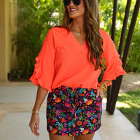 Fall in love with the Amy Ruffle Sleeve Top in Neon Coral! Made with bubble crepe fabric, this top is both comfortable and stylish. The v-neck neckline adds a touch of sophistication while the ruffle sleeves add a fun and feminine touch. Elevate your wardrobe with this must-have piece!
