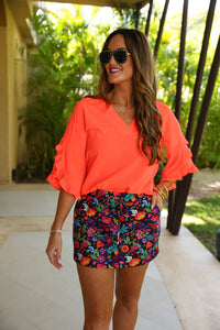 Fall in love with the Amy Ruffle Sleeve Top in Neon Coral! Made with bubble crepe fabric, this top is both comfortable and stylish. The v-neck neckline adds a touch of sophistication while the ruffle sleeves add a fun and feminine touch. Elevate your wardrobe with this must-have piece!