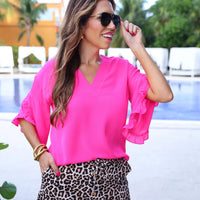 Fall in love with the Amy Ruffle Sleeve Top in Pink! Made with bubble crepe fabric, this top is both comfortable and stylish. The v-neck neckline adds a touch of sophistication while the ruffle sleeves add a fun and feminine touch. Elevate your wardrobe with this must-have piece!

