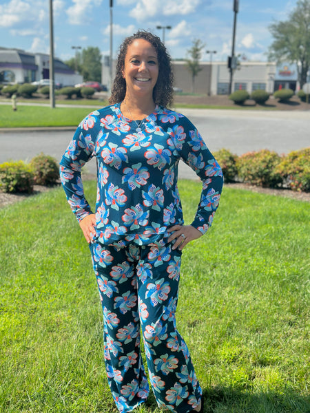 Slip into comfort with our Annie Pajamas, the perfect blend of cozy and cute. This two-piece set features a long sleeve scoop neck top and long pants with a 27” inseam. Designed with an elastic waistband, adjustable drawstring, and side pockets, these pajamas are made from a soft, stretchy blend of 94% polyester and 6% spandex—giving you that just-right feel for lounging or bedtime.