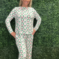 Slip into comfort with our Annie Pajamas, the perfect blend of cozy and cute. This two-piece set features a long sleeve scoop neck&nbsp;top and long pants with a 27” inseam. Designed with an elastic waistband, adjustable drawstring, and side pockets, these pajamas are made from a soft, stretchy blend of 94% polyester and 6% spandex—giving you that just-right feel for lounging or bedtime.