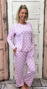 Slip into comfort with our Annie Pajamas, the perfect blend of cozy and cute. This two-piece set features a long sleeve scoop neck&nbsp;top and long pants with a 27” inseam. Designed with an elastic waistband, adjustable drawstring, and side pockets, these pajamas are made from a soft, stretchy blend of 94% polyester and 6% spandex—giving you that just-right feel for lounging or bedtime.