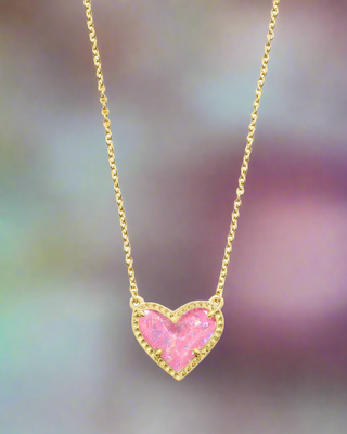 Brand | Kendra Scott
Style | Ari Heart pendant necklace with an asymmetrical heart design
Material | Pink Iridescent Glitter Glass
Finish | Gold tone
Chain Length | 15 inches with a 2-inch extender
Pendant Size | 0.57 inches long x 0.49 inches wide