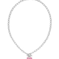 Fall for the Ari Heart Silver Necklace in Pink Iridescent Glitter Glass! Featuring a heart charm, enamel frame, and trendy link chain with toggle closure, it’s convertible too!