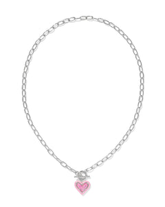 Fall for the Ari Heart Silver Necklace in Pink Iridescent Glitter Glass! Featuring a heart charm, enamel frame, and trendy link chain with toggle closure, it’s convertible too!