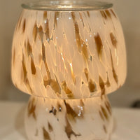 Stylish midcentury-inspired glass wax warmer with vintage bulb and soft amber glow. A flame-free, elegant way to fill your home with fragrance.