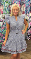 This charming 100% cotton dress features classic navy pinstripes, flutter sleeves, and a flattering tiered silhouette. The elastic waistband adds all-day comfort while the colorful embroidered hem brings a fun, feminine touch. Lightweight and breathable—perfect for warm-weather outings, vacations, or casual days out.
