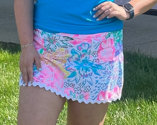 The Amelie Lace Detail Hem Skort in Garden Party combines a playful print with a delicate lace hem for a look that's equal parts feminine and functional — effortlessly polished from brunch to the boardwalk.

Fit | Soft, flattering silhouette with a comfortable waistband
Fabric | UPF 50+ sun-protective fabric
Detail | Delicate lace hem for a romantic, elevated finish
Print | Garden Party — fresh, warm-weather-ready
Built-in shorts | Full coverage for active wear, travel, and outdoor activities
