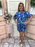 This chic shorts romper features a scoop neck with ruffle details on the hem and cuffs. Flattering, comfy, and a gorgeous shade of blue with UPF50 protection.
