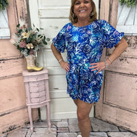 This chic shorts romper features a scoop neck with ruffle details on the hem and cuffs. Flattering, comfy, and a gorgeous shade of blue with UPF50 protection.