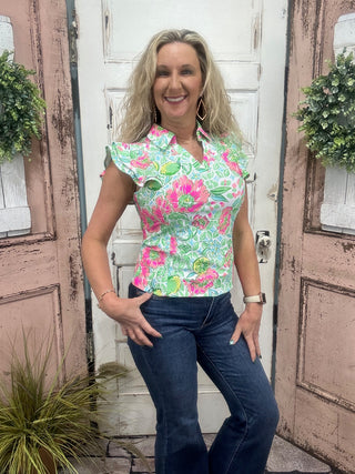 Pink Citrus Bloom sleeveless ruffle polo with UPF50 sun protection and wrinkle-free fabric.

Pattern Features: Pink/Green Floral Print with Lemons/Limes with in the floral print