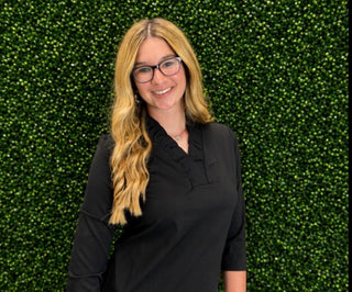 Aryeh Tabatha Ruffle Neck Top  in Black 
UPF 50 sun protection fabric 
three quarter sleeve top with v-neck ruffle collar detail