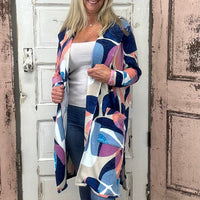 Wrap yourself in warmth and style with the Bailey Cardigan, showcasing a beautiful sunset mosaic print that adds a pop of color to any outfit. Made from a cozy and flexible blend of 85% polyester, 10% viscose, and 5% spandex, this cardigan offers softness and stretch for comfortable layering all day long.