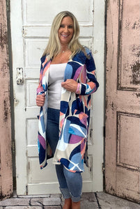 Wrap yourself in warmth and style with the Bailey Cardigan, showcasing a beautiful sunset mosaic print that adds a pop of color to any outfit. Made from a cozy and flexible blend of 85% polyester, 10% viscose, and 5% spandex, this cardigan offers softness and stretch for comfortable layering all day long.