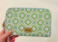 Lilly Pulitzer zipper wallet, Bamboo Logo Trellis wallet, travel organizer wallet, passport wallet, Lilly Pulitzer travel accessories, zipper wallet with pockets, stylish travel wallet. Lilly Pulitzer Bamboo Logo Trellis zipper wallet with gold logo plaque and bamboo zipper pull, designed for travel essentials
