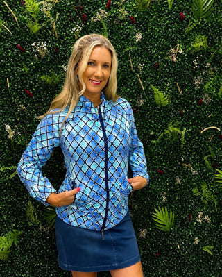 A woman wearing a blue and white diamond-patterned zip-up jacket 