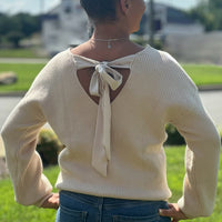 Chic, cozy, and on-trend — this Bow Sweater is a must-have for the season! Featuring adorable bow accents, this stylish piece easily transitions from casual to dressy. Whether you're pairing it with your favorite jeans for a laid-back look or dressing it up with tailored pants and boots, this sweater adds a feminine touch to any outfit. Soft, comfortable, and effortlessly cute — it’s sure to become a go-to in your wardrobe.