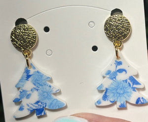 Timeless with a touch of festive flair, these Blue and White Toile Christmas Tree Dangle Earrings bring elegance to your holiday look. Featuring a classic toile pattern in blue and white, topped with a shiny blue mirrored bow, they’re the perfect accessory for a sophisticated seasonal statement. Lightweight, hypoallergenic, and nickel-free for all-day comfort.


