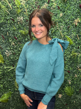 Style | Off-Shoulder Sweater
Color | Green
Neckline | Off-shoulder
Sleeves | Lantern sleeves with bow tie detail
Fabric | Elastane (Spandex) blend — soft, stretchy knit
Fit | Fitted through the body with a flowy sleeve silhouette
Care | Hand wash cold or machine wash gentle, lay flat to dry
