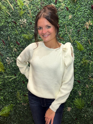 Style | Off-Shoulder Sweater
Color | White
Neckline | Off-shoulder
Sleeves | Lantern sleeves with bow tie detail
Fabric | Elastane (Spandex) blend — soft, stretchy knit
Fit | Fitted through the body with a flowy sleeve silhouette