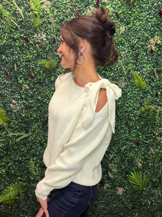 Style | Off-Shoulder Sweater
Color | White
Neckline | Off-shoulder
Sleeves | Lantern sleeves with bow tie detail
Fabric | Elastane (Spandex) blend — soft, stretchy knit
Fit | Fitted through the body with a flowy sleeve silhouette