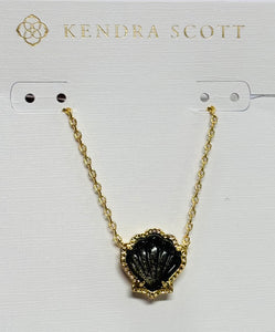 Embrace coastal vibes with the Brynne Gold Shell Pendant Necklace in Golden Obsidian. Its textured details and chic shell design shine solo or stacked.