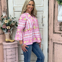 The yarn-dyed jacquard fabric, pearl-edged sleeves, and flounce waist combine for a feminine, flattering silhouette with a touch of flair.