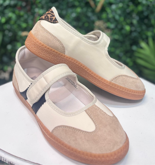 Meet the sneaker that makes everyday outfits feel instantly more pulled together. The Corkys Calm Down Mary Jane features a soft Sand Combo palette with creamy ivory panels, warm sand-toned texture, and a playful leopard-print accent at the heel. A tan sole grounds the look, while the classic Mary Jane strap keeps the silhouette feminine and easy to wear.
