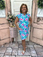 Turn heads in the Cambria Shift Dress - Flamingo Paradise! Featuring a V-neck, cap sleeves, and a comfy stretch fit, this vibrant dress is perfect for any occasion.
