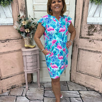 Turn heads in the Cambria Shift Dress - Flamingo Paradise! Featuring a V-neck, cap sleeves, and a comfy stretch fit, this vibrant dress is perfect for any occasion.