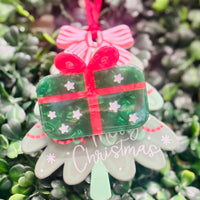 Festive acrylic Christmas claw clips in tree, gingerbread man, present, and snowman designs. Perfect for holiday hairstyles!