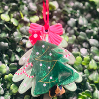 Festive acrylic Christmas claw clips in tree, gingerbread man, present, and snowman designs. Perfect for holiday hairstyles!